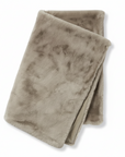 Folded beige blanket on a white background