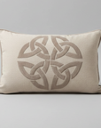 Decorative pillow with Celtic knot pattern on a white sofa