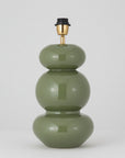 Green lamp with gold and black accents on a white background