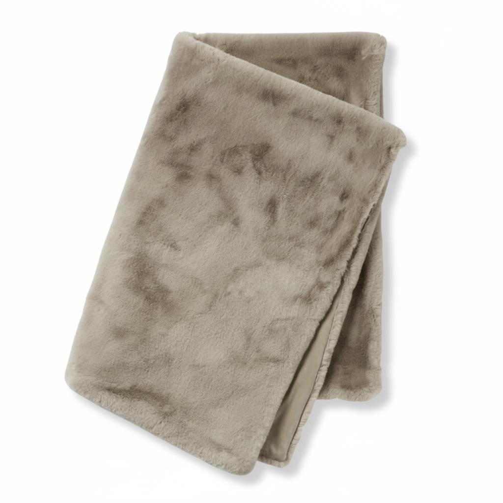 Folded beige blanket on a white background