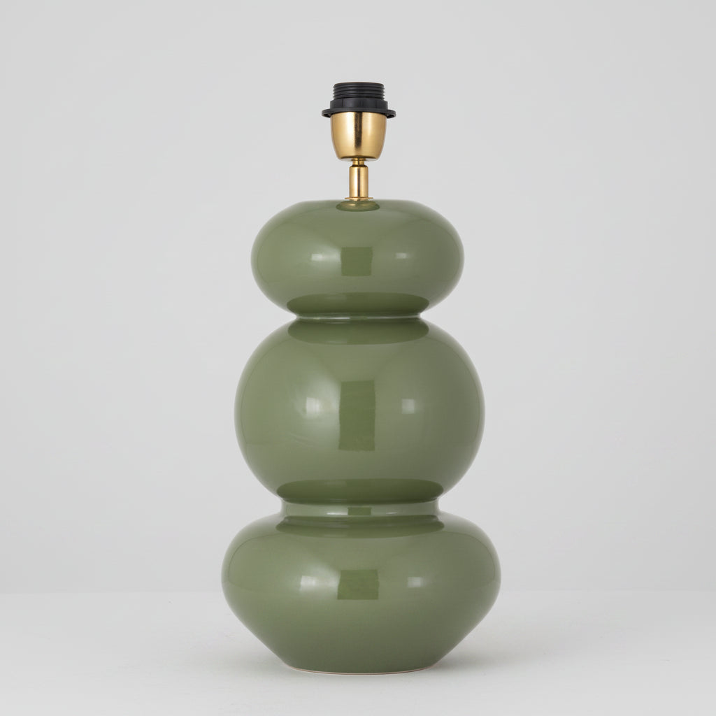 Green lamp with gold and black accents on a white background